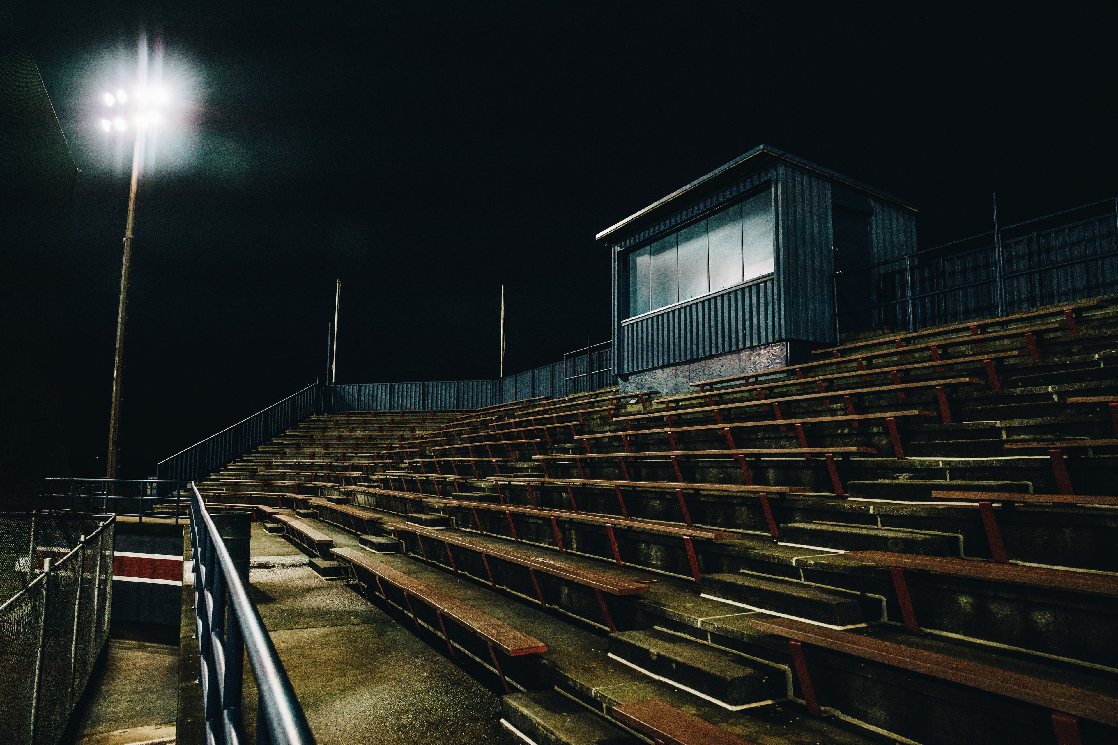 Empty sports field stands representing the journey to building an elite athlete mindset with Elite Footy Mentality.