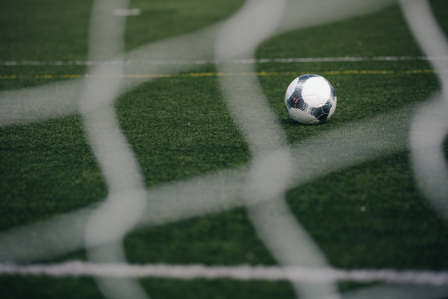 Soccer ball going through the net, symbolizing the turning point for an athlete who transformed their mindset and scored after adopting a new approach, as part of the journey with Elite Footy Mentality.